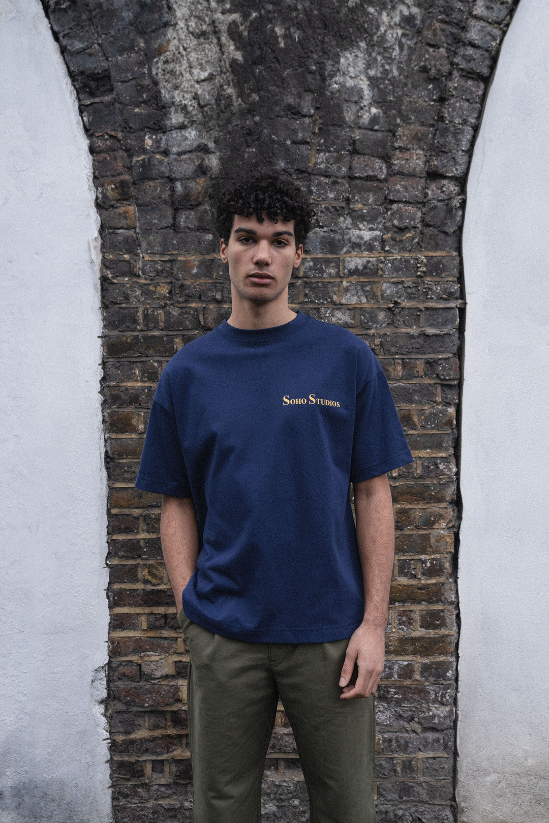 A navy blue t-shirt with a yellow and gold screen printed logo