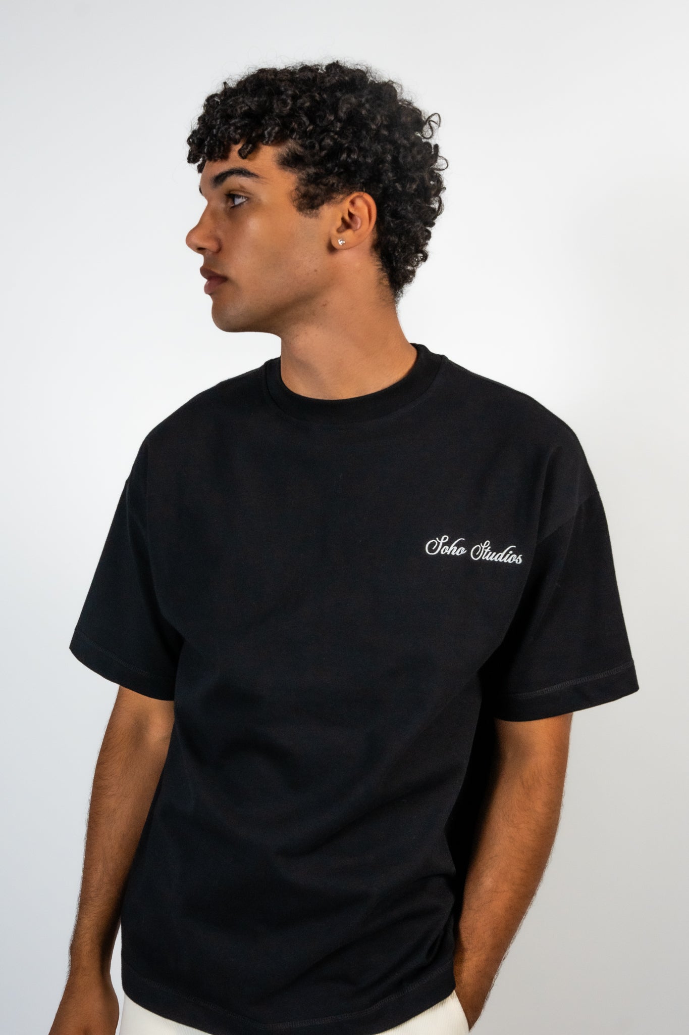 Men wearing A black t-shirt with striped detailing and an embroidered logo on the left chest.