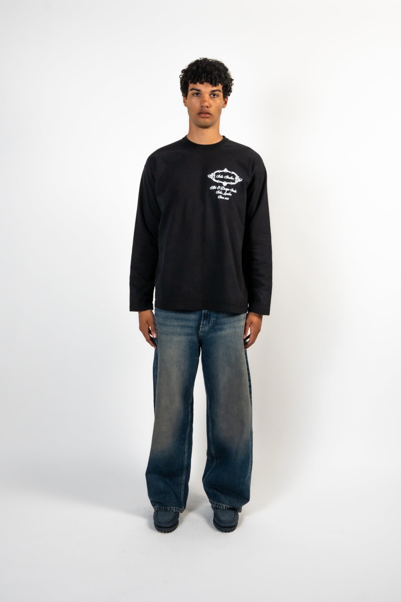 Men Wearing Black Soho Studios long sleeve t-shirt with white chest logo print