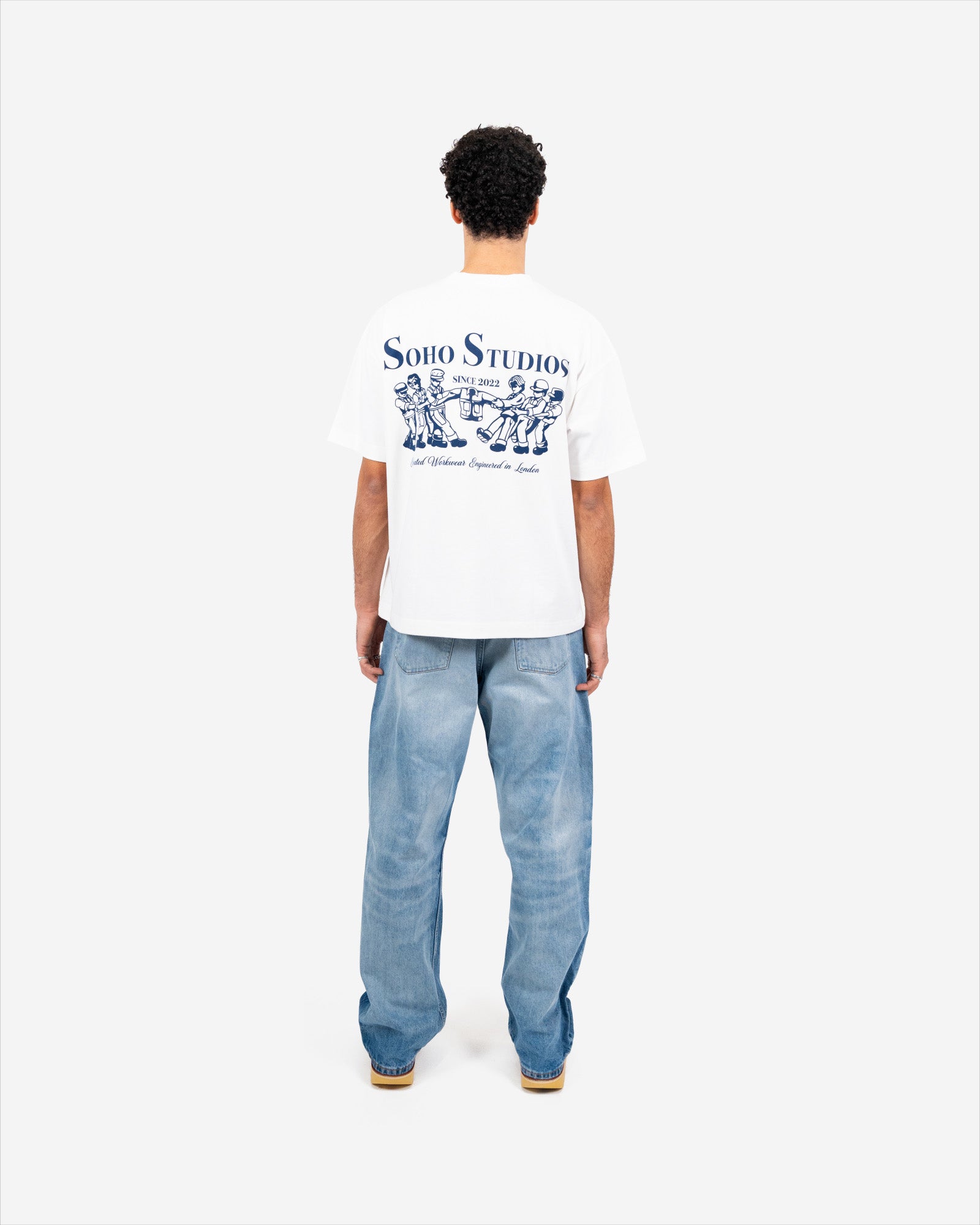 men wearing VINTAGE WHITE 'GRAFTER' T-SHIRT showing his back 