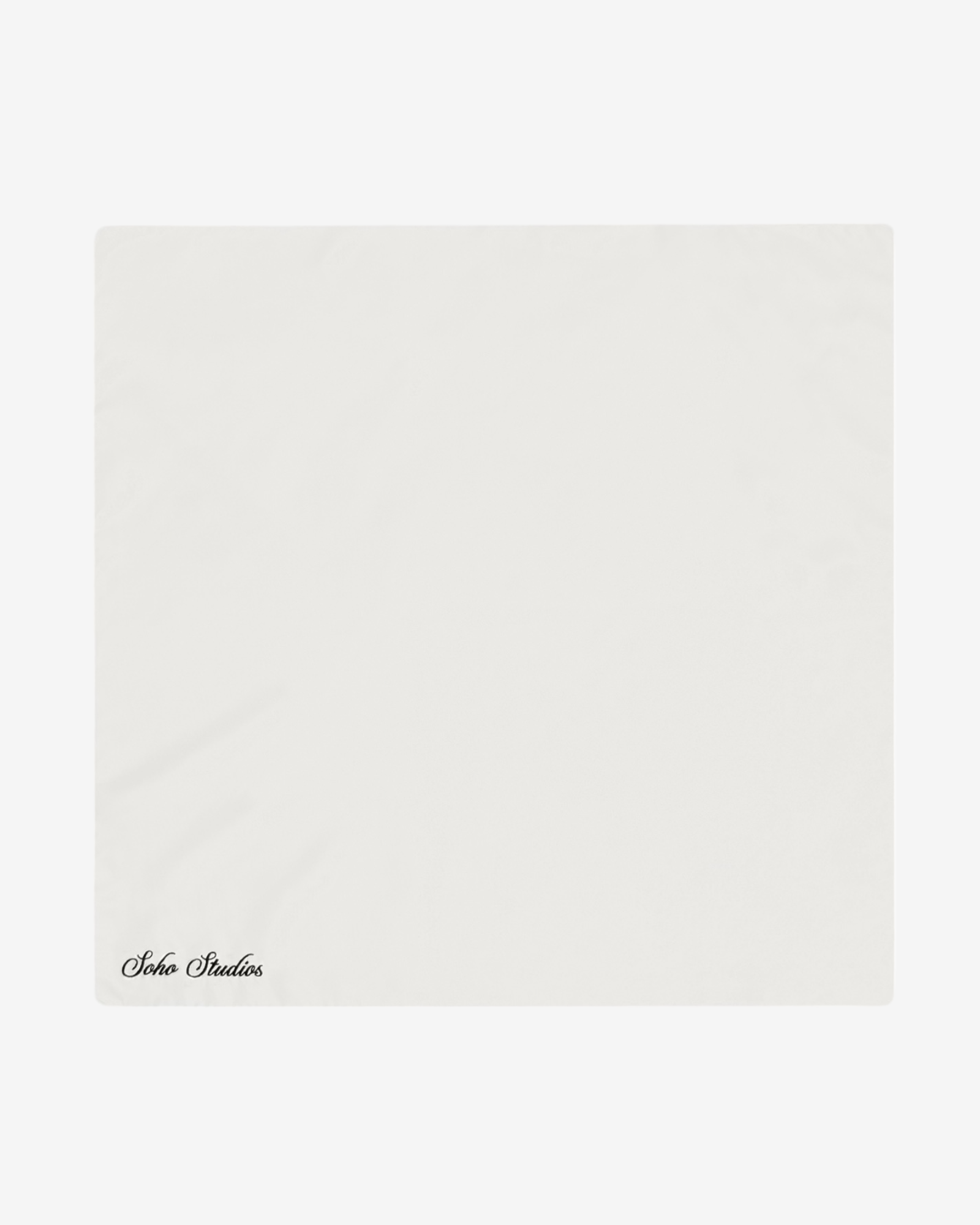 A solid white silk necktie with 'Soho Studios' text at the bottom.