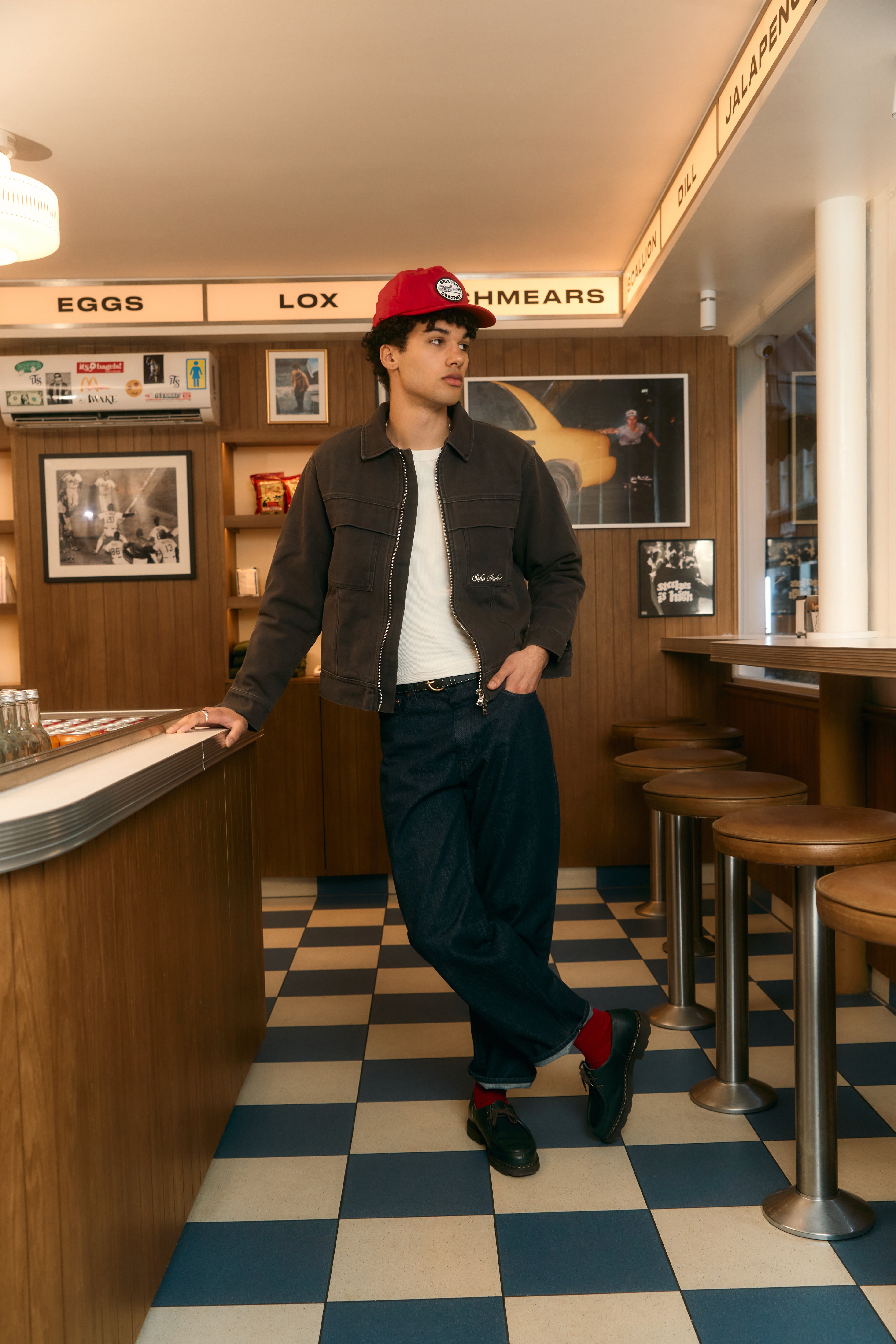 Men wearing VINTAGE WASH TRUCKER JACKET in a bar setting.